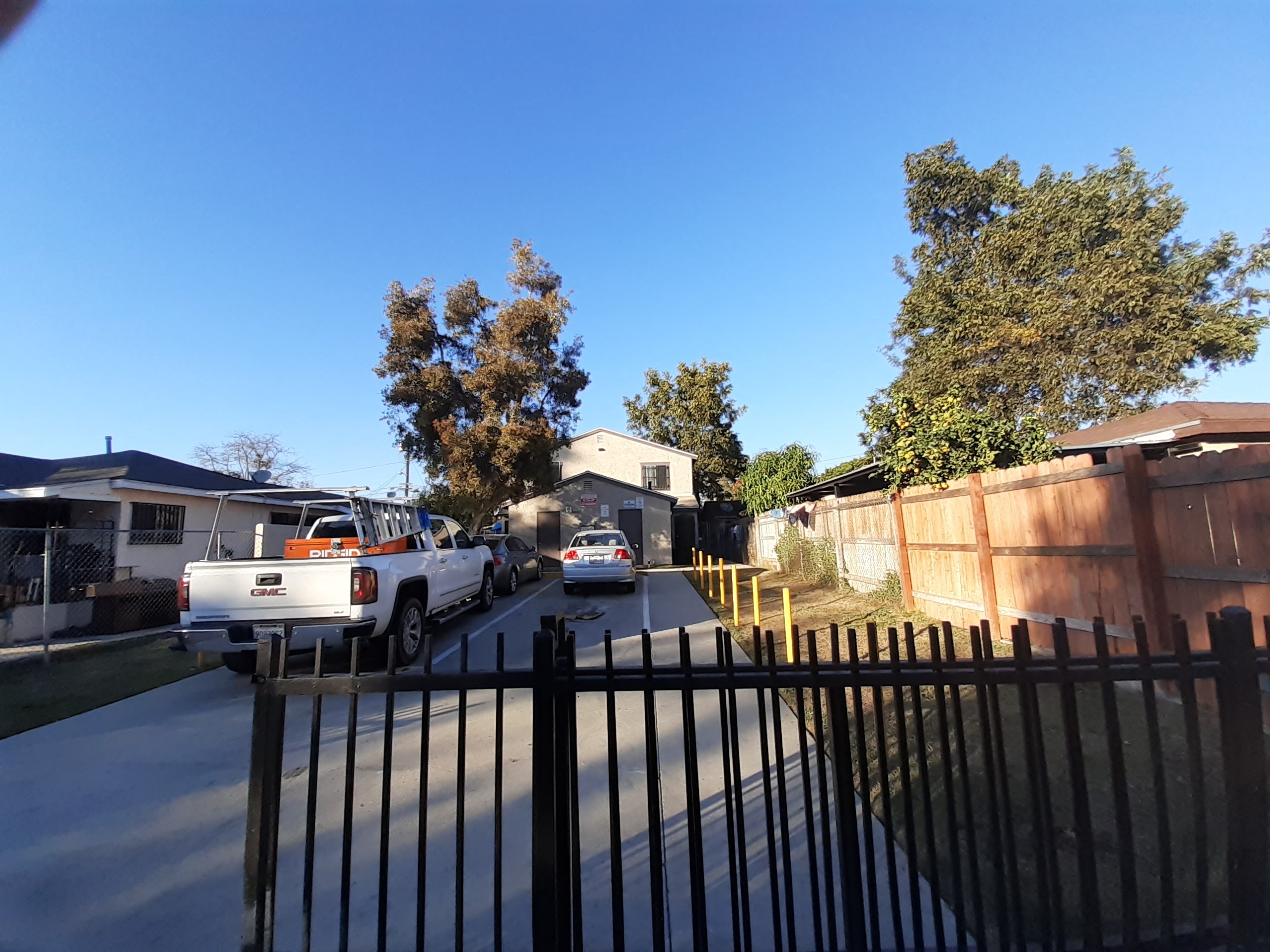 A white truck is parked on a driveway.